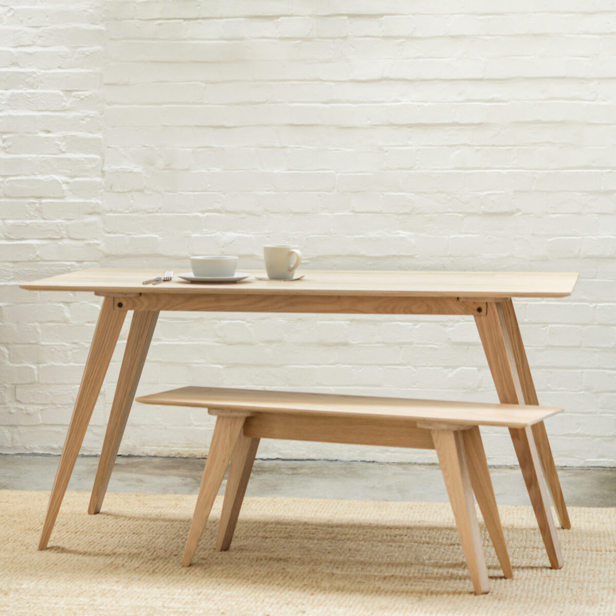A modern, Scandinavian inspired Brenin Bench Seat and Brenin Dining Table made from Birch plywood with natural wood veneer sit in perfect harmony; ready for a relaxed Sunday morning breakfast.