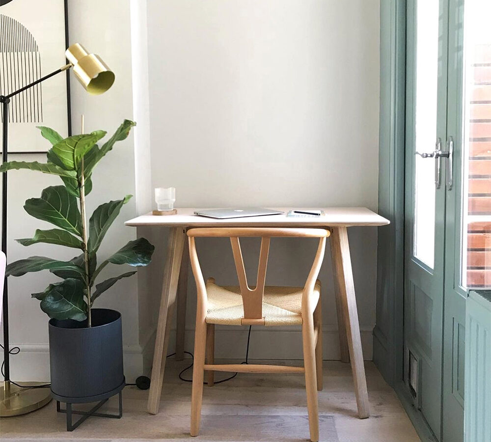 A Scandinavian inspired Brenin Desk Table sits in a corner of a calm home office. It's elegant design is modern and made from hard-wearing, natural materials.